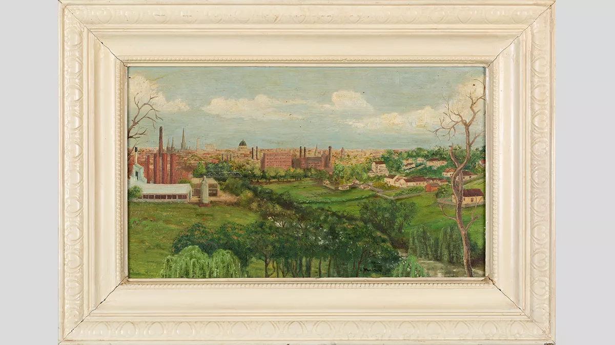 Framed painting of a green landscape of fields which borders on the start of a city