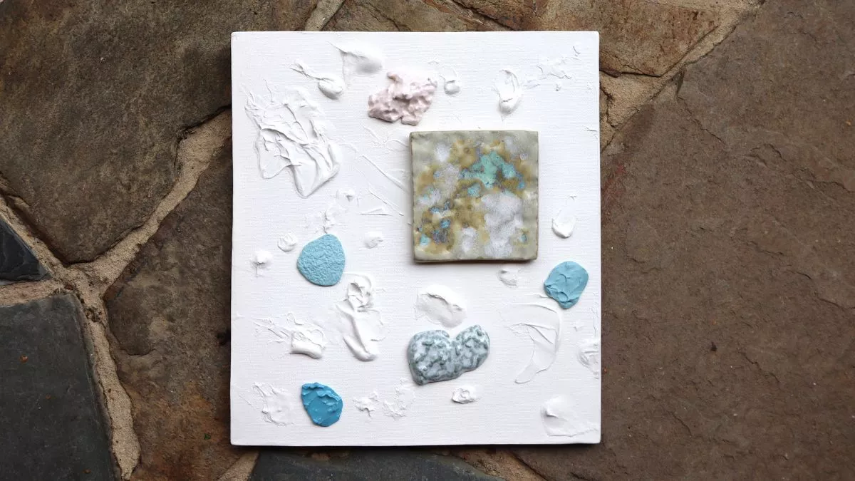 Dabs of paint on canvas with a small painted square absract art