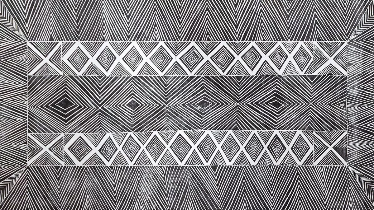 white print of geometric shapes on a crosshatch black-and-white background