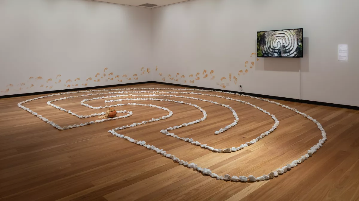 small rocks arranged in a shape on a timber floor