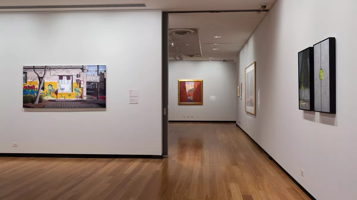 paintings on the wall of an art exhibition