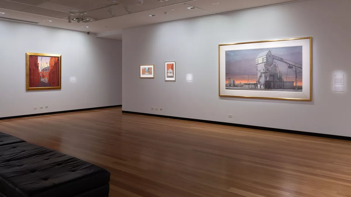 Painting of an industrial building on the wall of an art gallery