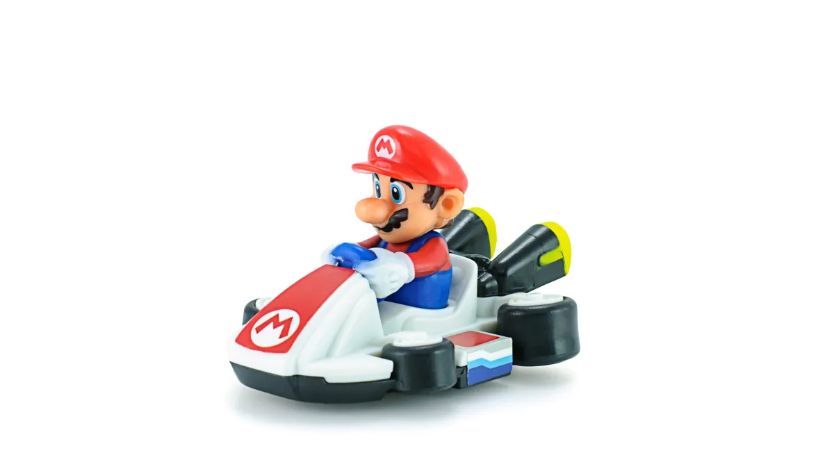 A figurine of Mario driving a gocart from Mariocart