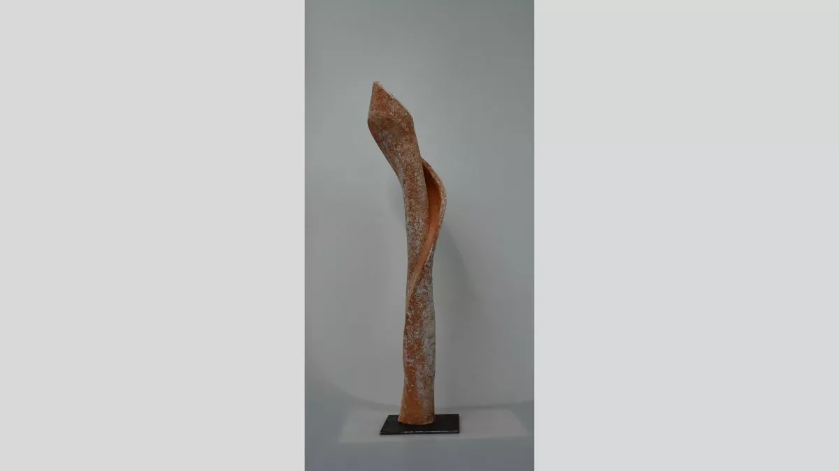 Vertical, cylindrical sculpture reminiscent of an orchid in orange and white