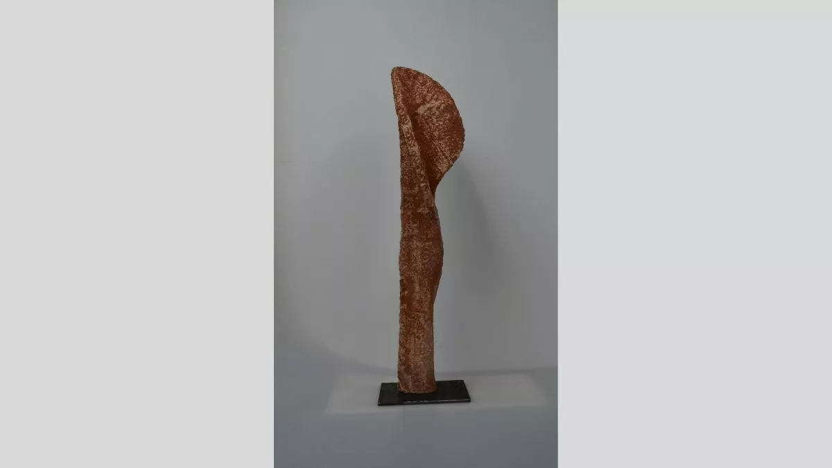Vertical sculpture like a petal unfurling in red and orange