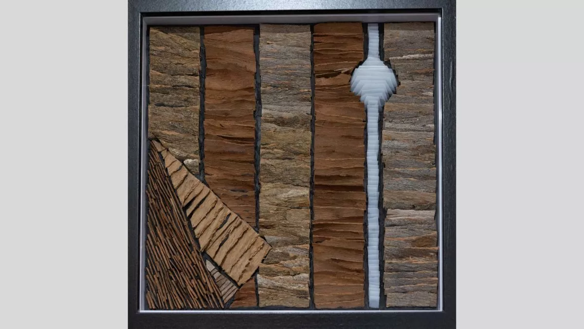 An artwork made of layered pieces of coloured wood that are arranged in vertical strips down the canvas with one thin strip of layered pieces of white, and the bottom left corner in a separate section of thin diagonal wooden pieces