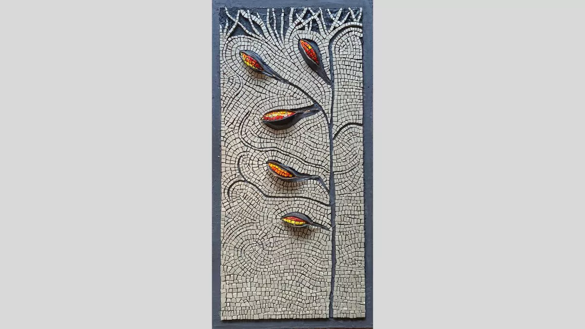 An artwork featuring a mosaic with the depiction of a flower with red and yellow pods, surrounded by beige mosaic tiles with root-like tendrils at the top