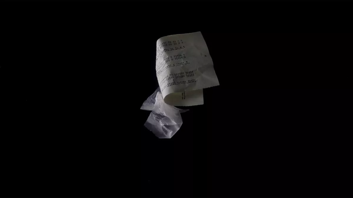 Single pieces of crumpled paper and plastic floating against a black background.