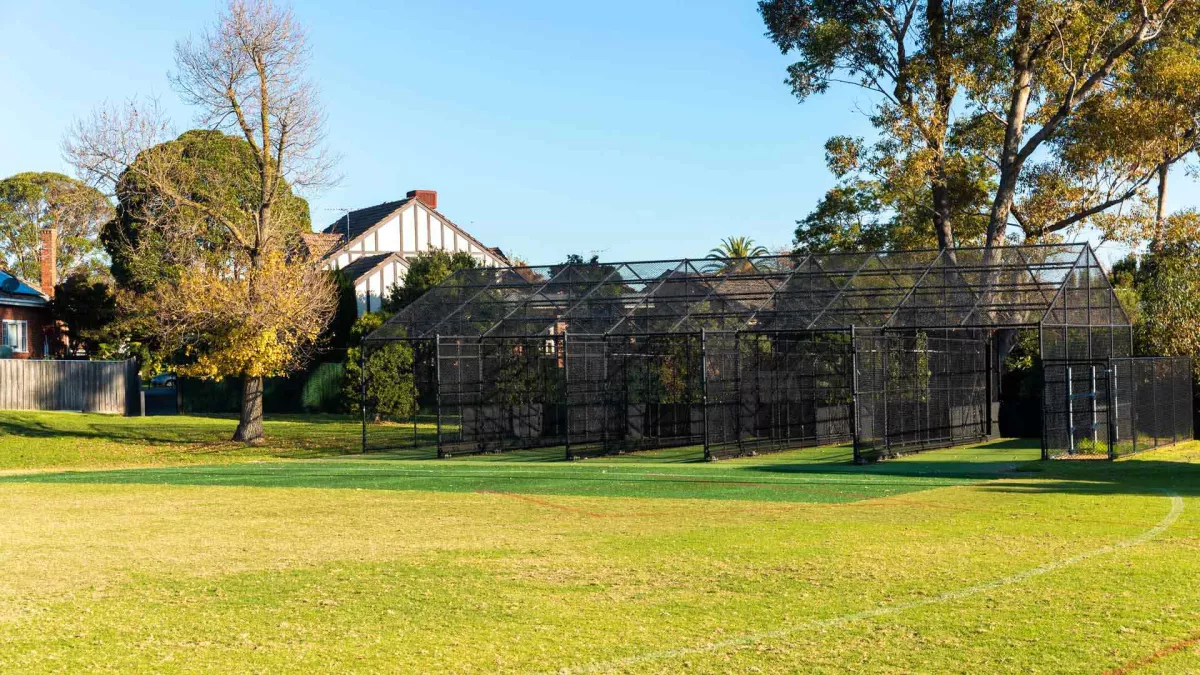 A black mental structure with 4 lanes on artificial turf grass