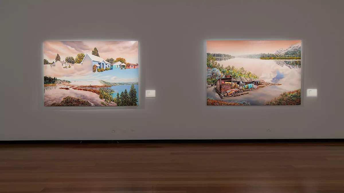 Photograph of large landscape paintings hanging in a gallery
