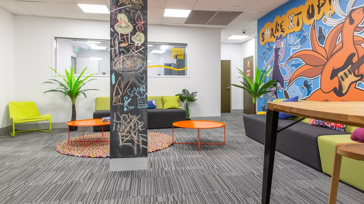 A carpeted, colourful room