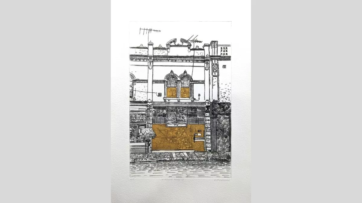 An etching of a shopfront with sections of gold leaf in the windows.