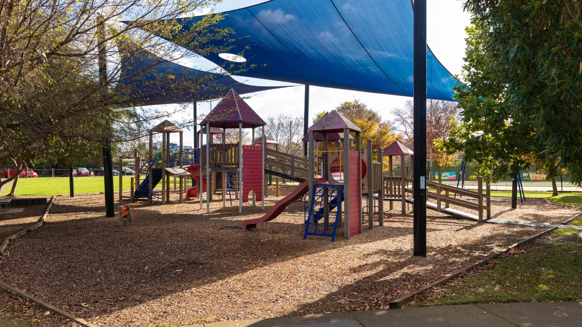 A playground for very young children with a large shade sail