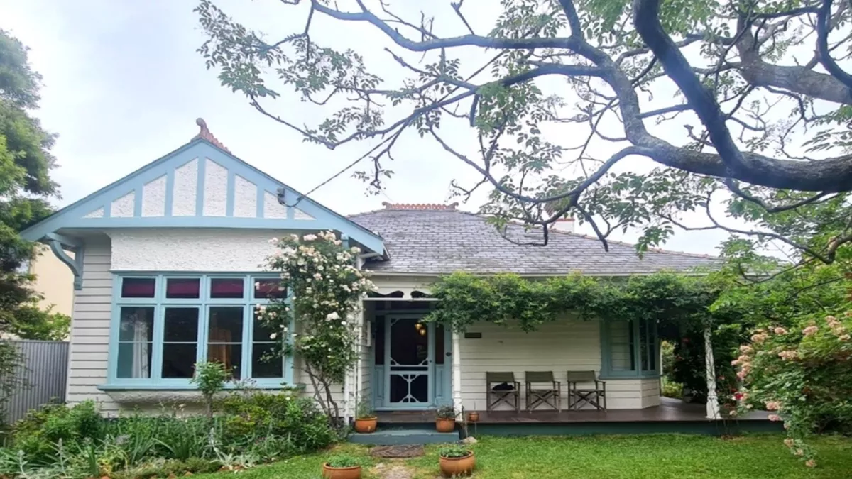 The front of a blue and white weatherboard house