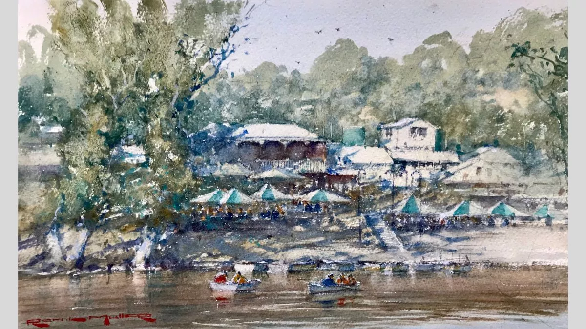 Watercolour painting of a boathouse by the river. There are small boast in the river in the foreground.