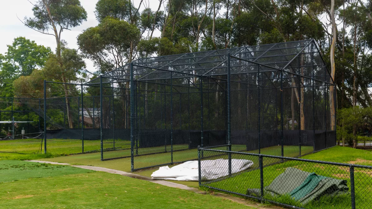Cricket nets at a sportsground with trees in the background