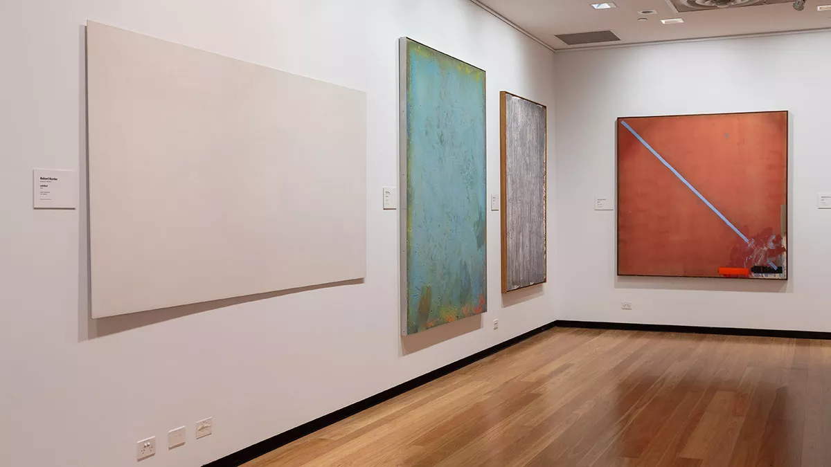 Installation view of abstract paintings hanging in a gallery
