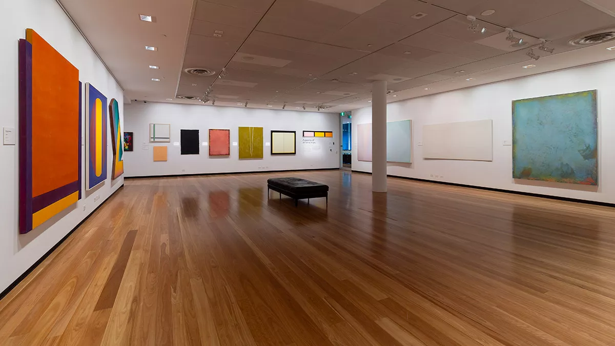 Installation view of abstract paintings hanging in a gallery