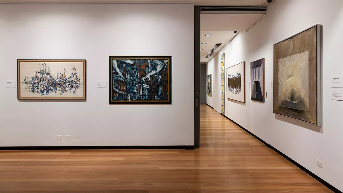 Installation view of abstract paintings hanging in a gallery