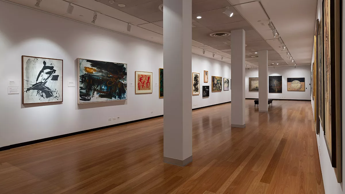 Installation view of abstract paintings hanging in a gallery