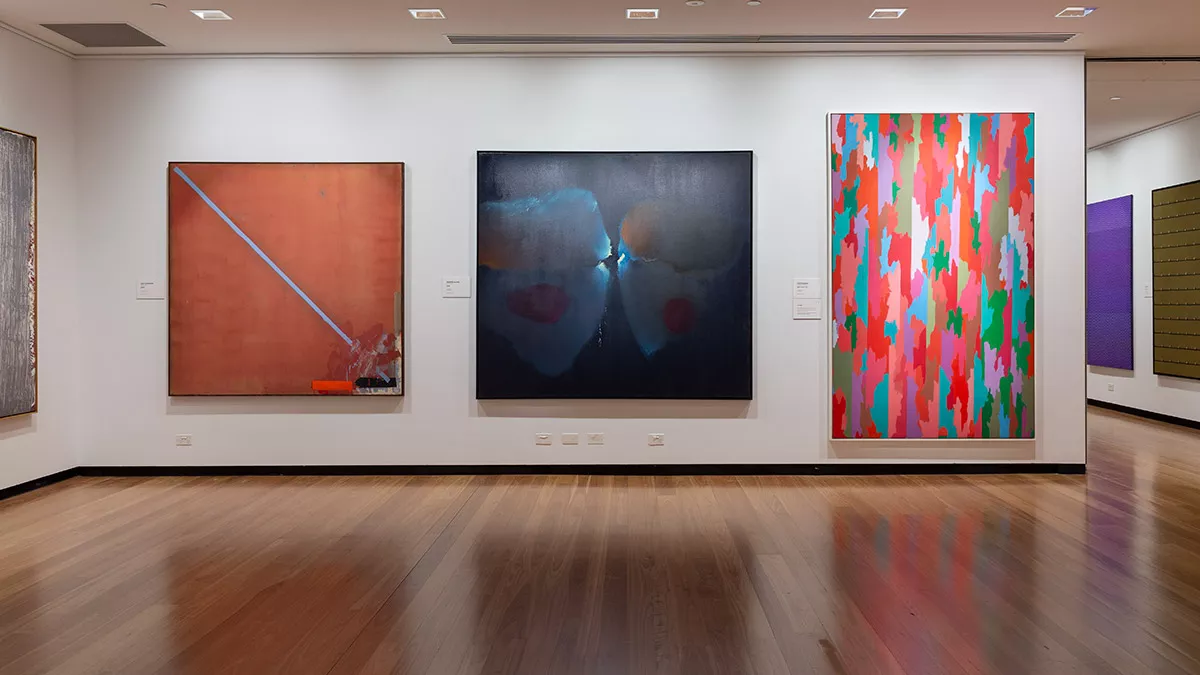 Installation view of abstract paintings hanging in a gallery