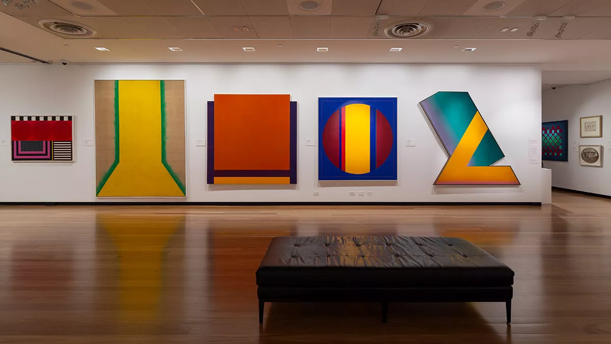 Installation view of abstract paintings hanging in a gallery