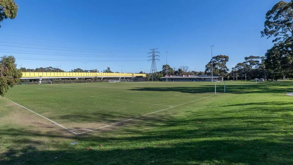 A rectangular sportsground with soccer goal posts