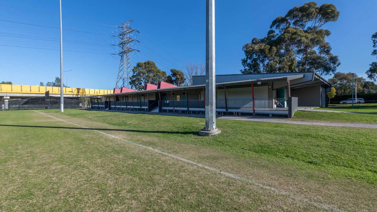 A building on the edge of a sportsgrounf. 