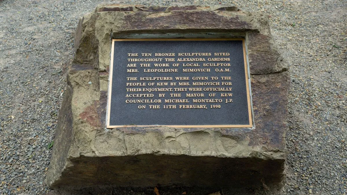 A bronze plaque attached to a large stone