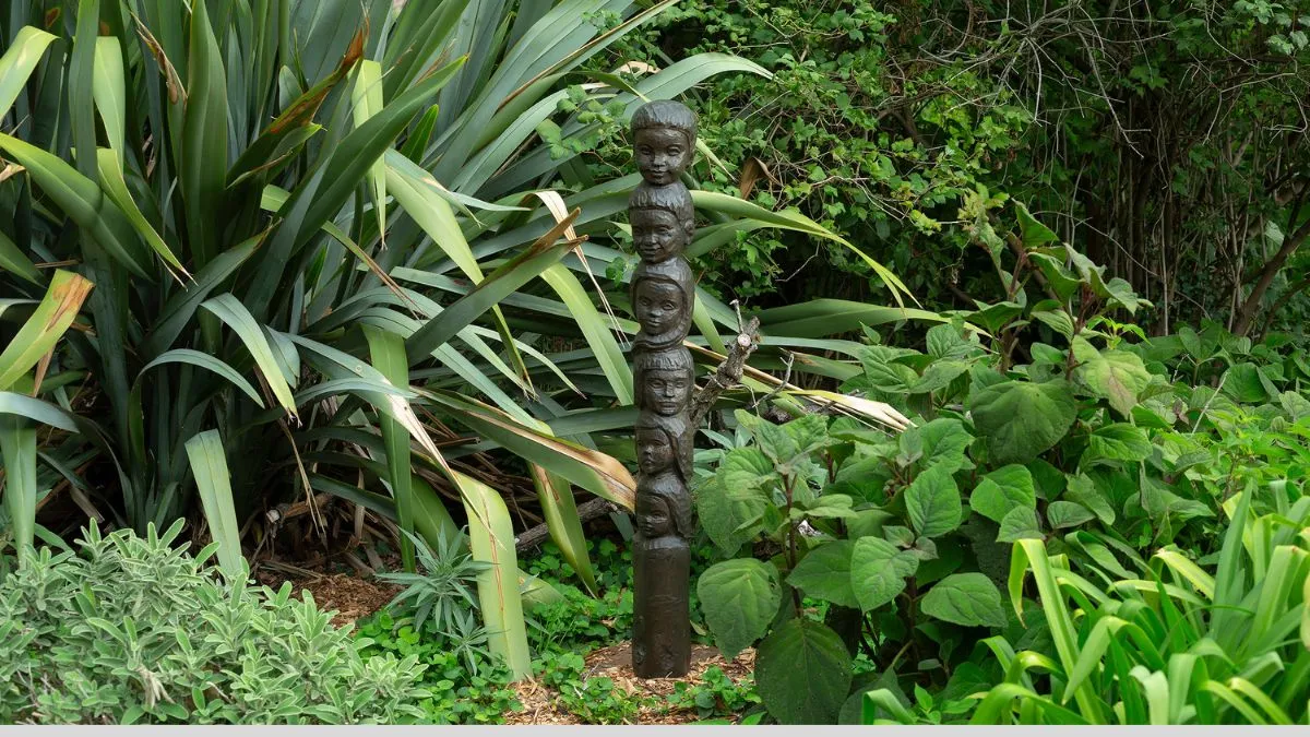 A bronze statue featuring a tower of heads.