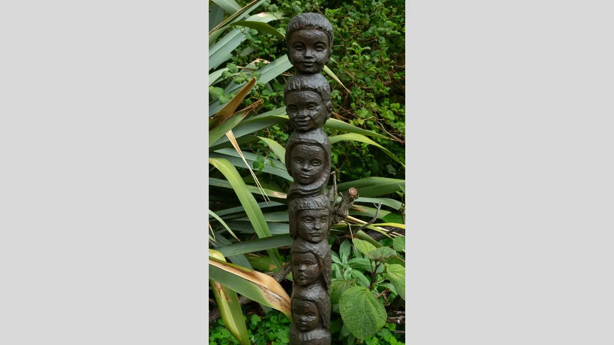 A bronze statue featuring a tower of heads.