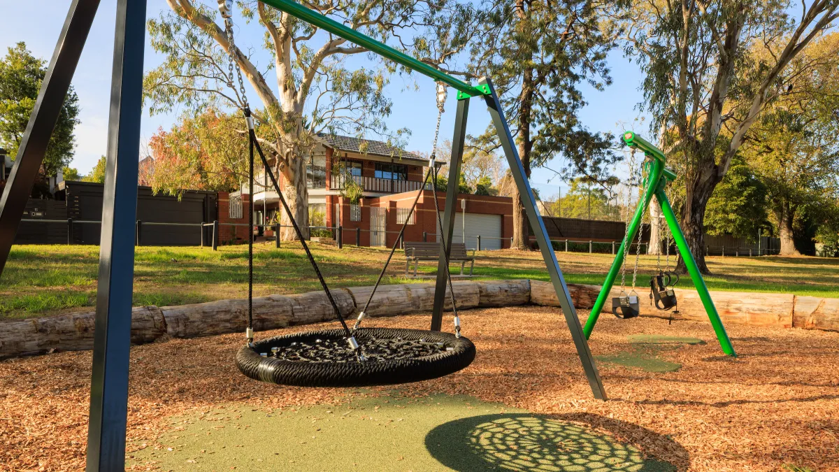 A large hammock-style rope swing in a playground