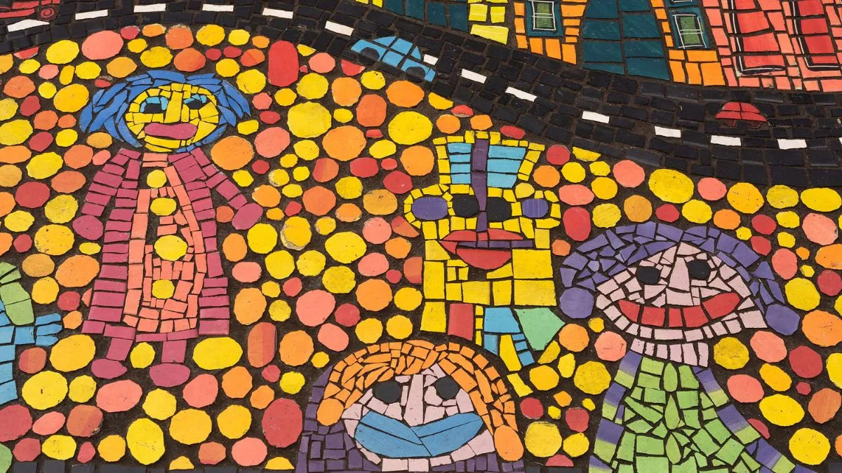 A colourful mosaic of smiling people on a dotted yellow, red and orange background