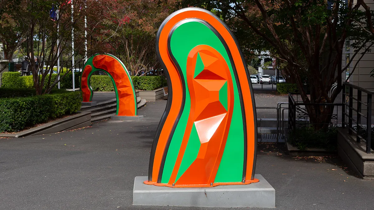 Large, abstract, orange and green public sculpture
