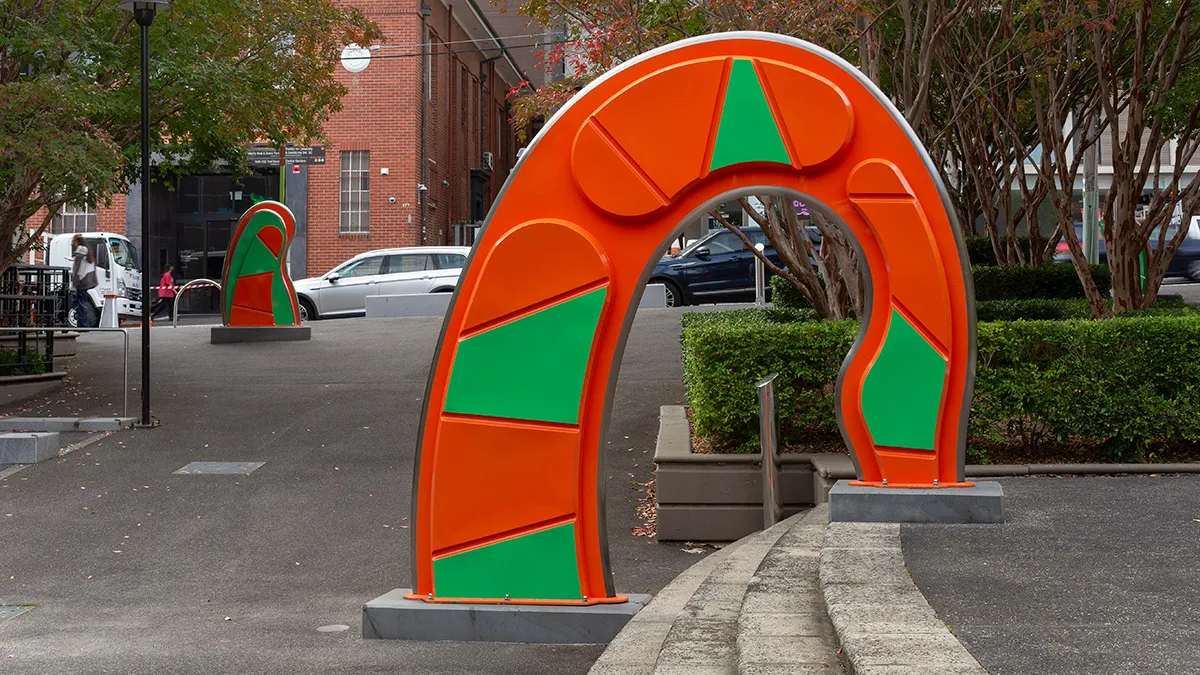 Large, abstract, orange and green public sculpture