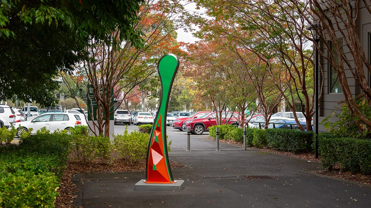 Large, abstract, orange and green public sculpture