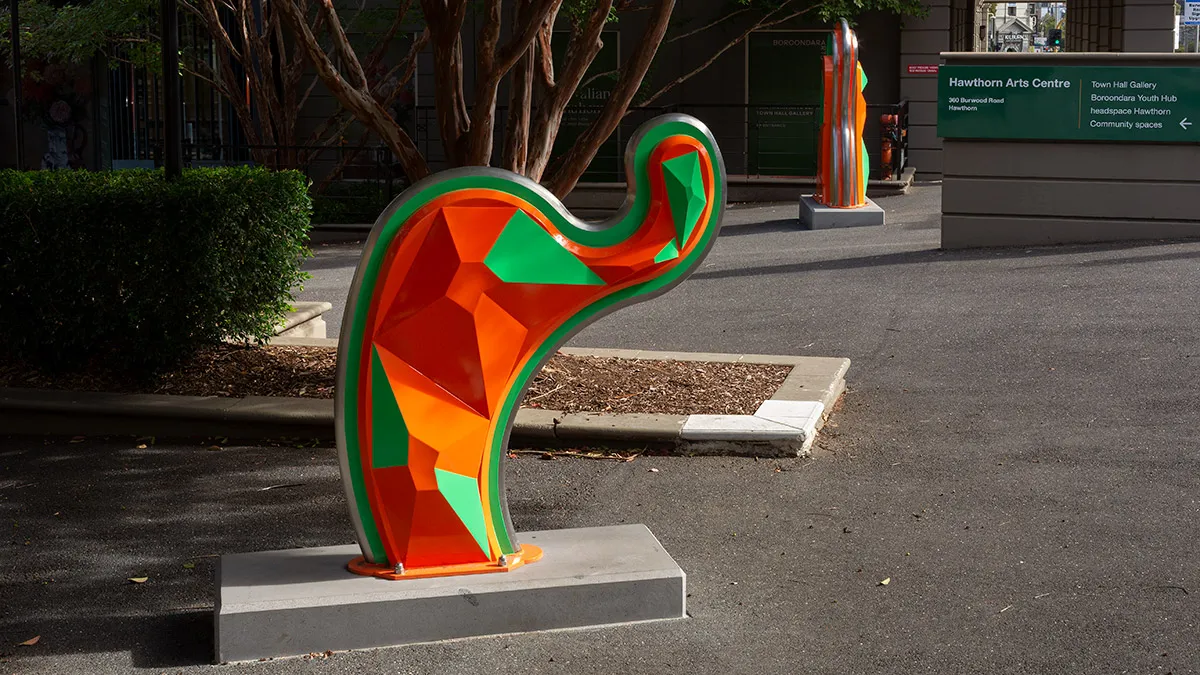 Large, abstract, orange and green public sculpture