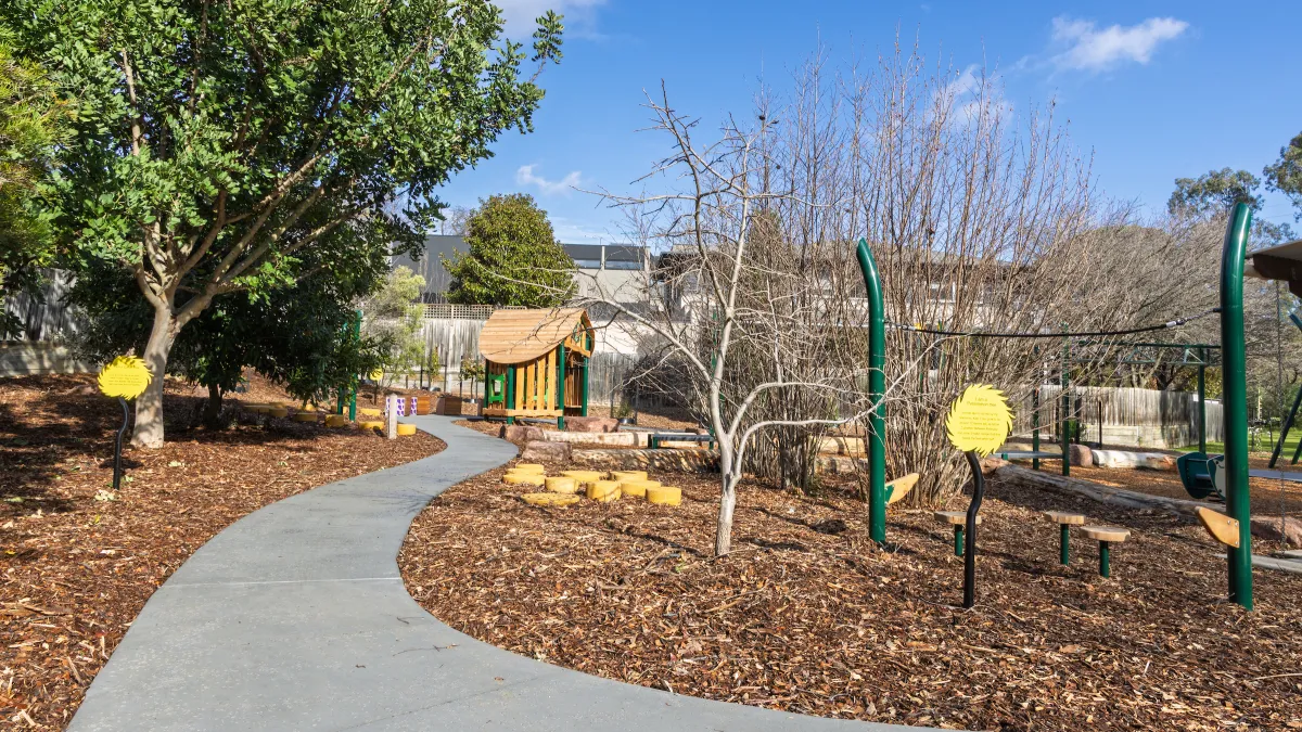 A sealed pathway leading to a playground