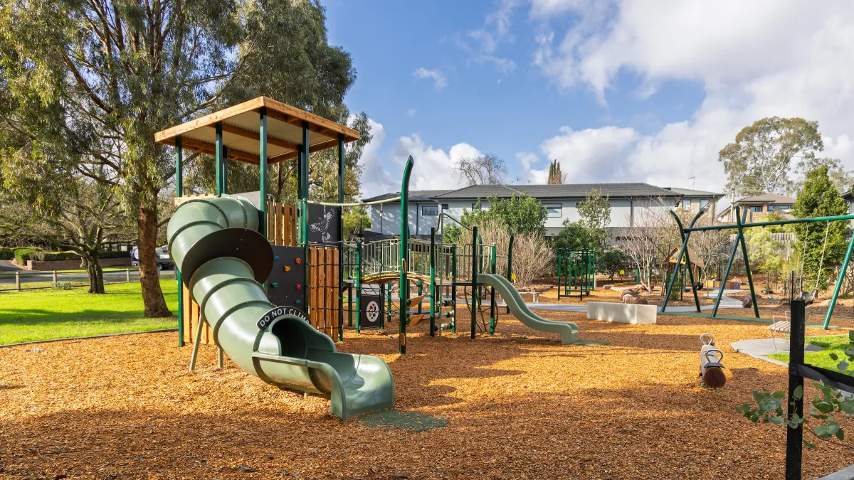a small playground with a covered slide