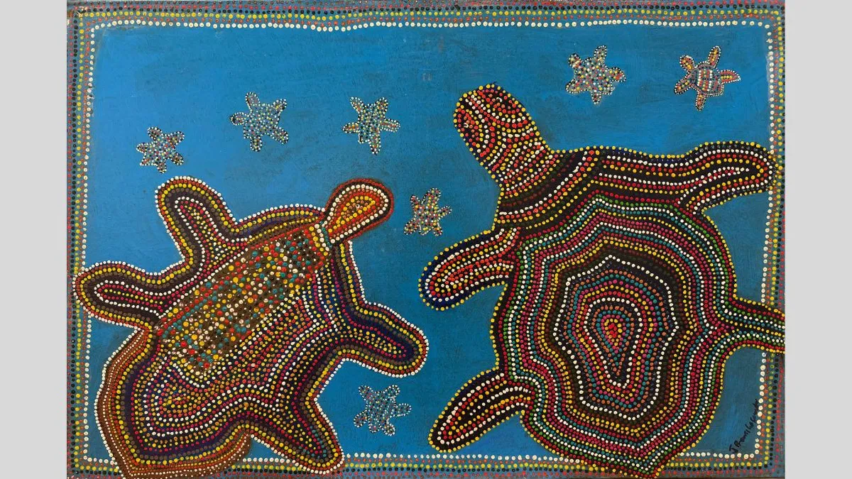 A painting of two turtles depicted in dot painting style with concentric patterns in red, yellow, white, and green on a blue background. Smaller turtles surround them, and a dotted border frames the composition.