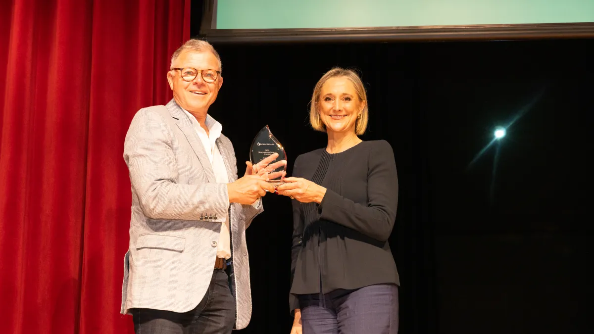 A man accepts a trophy from Lord Mayor Sophie Torney