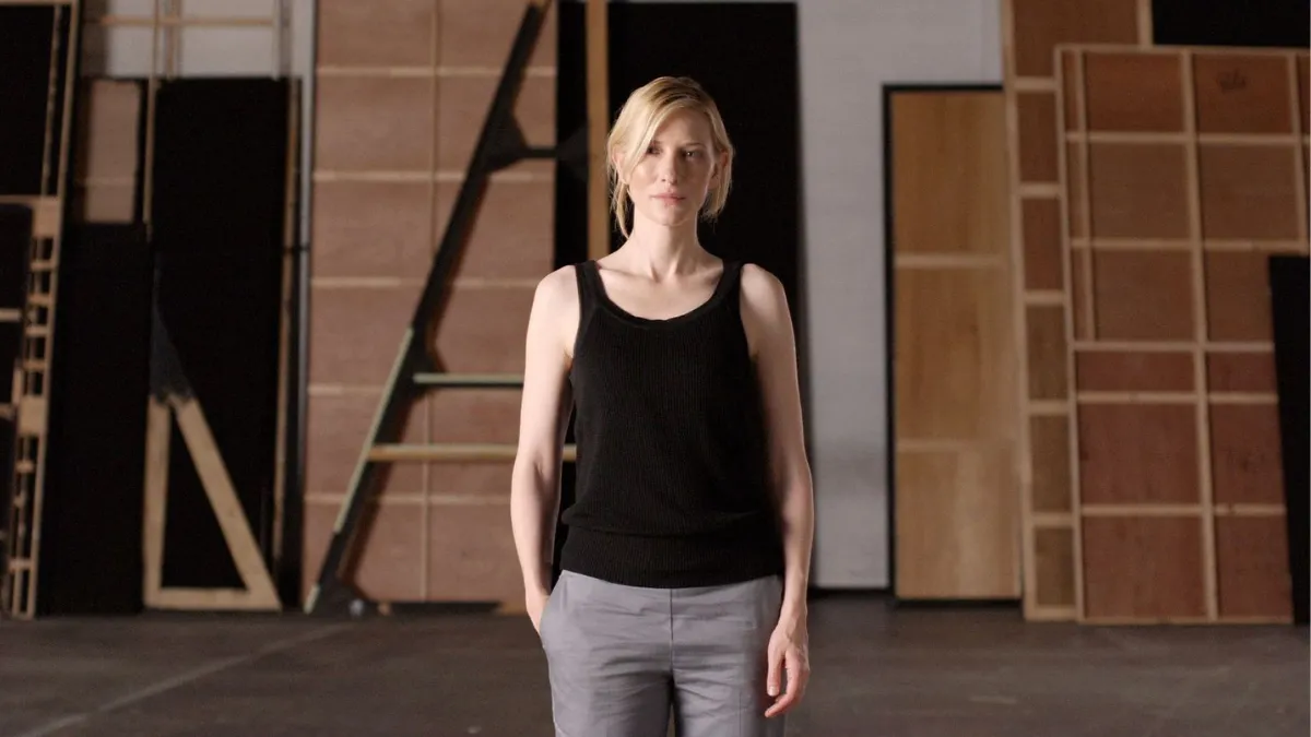 Portrait of actor Cate Blanchett standing front on within a theatre setting