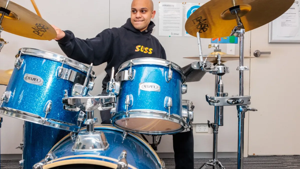 A man plays the drums.
