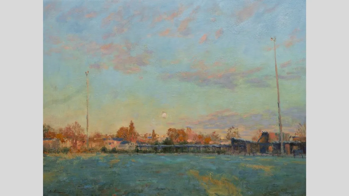 Painting of an open field with green grass. There are trees and small buildings along the horizon, a pale moon sits in the centre and the sky is cloudy with a blend of pale green, blue, pink and purple pastels. 