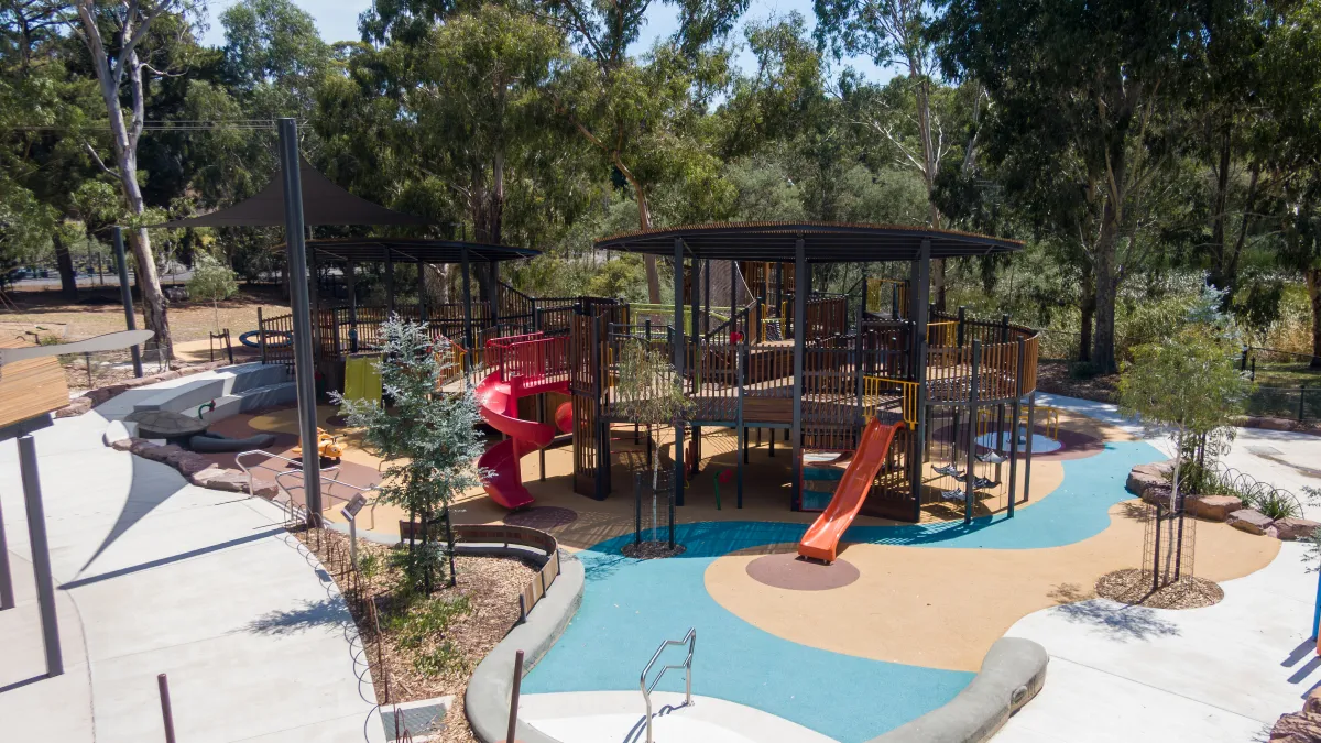 A playground with trees in the background.
