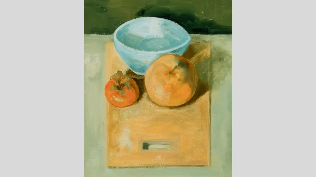 Image of a still life painting showing a blue bowl, an orange and a persimmon placed close together on a light wooden board. The background is divided into muted green tones and the brushwork is soft and painterly. 