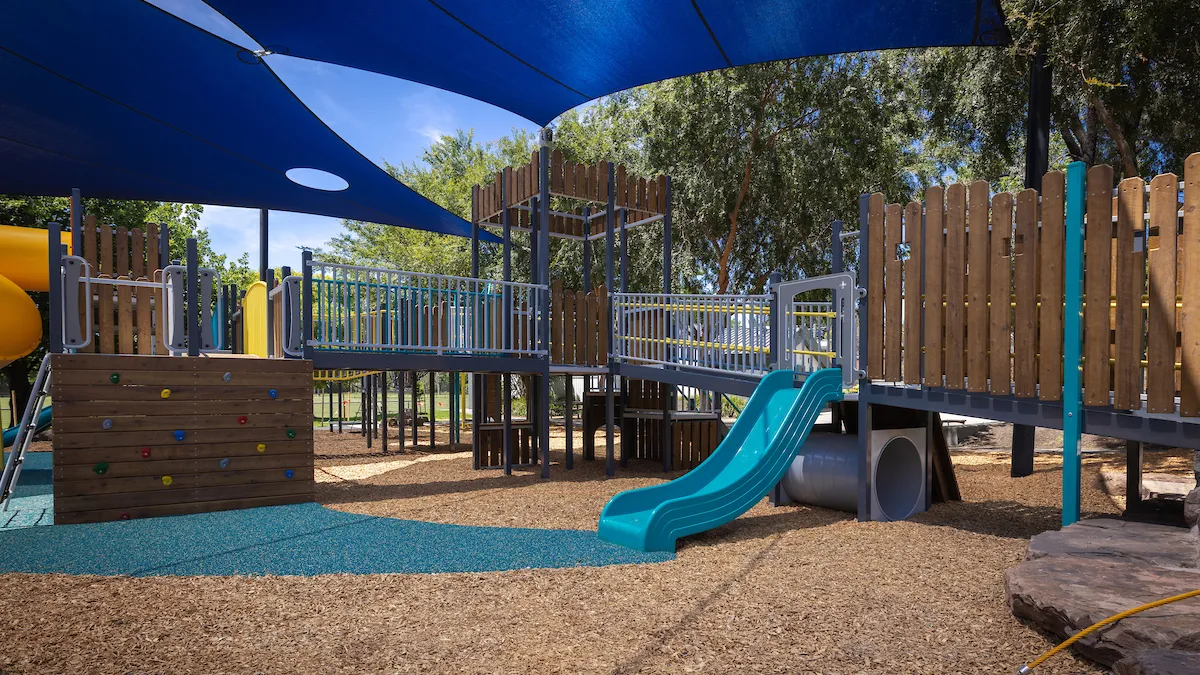shadecloth over a toddler's slide in a playground