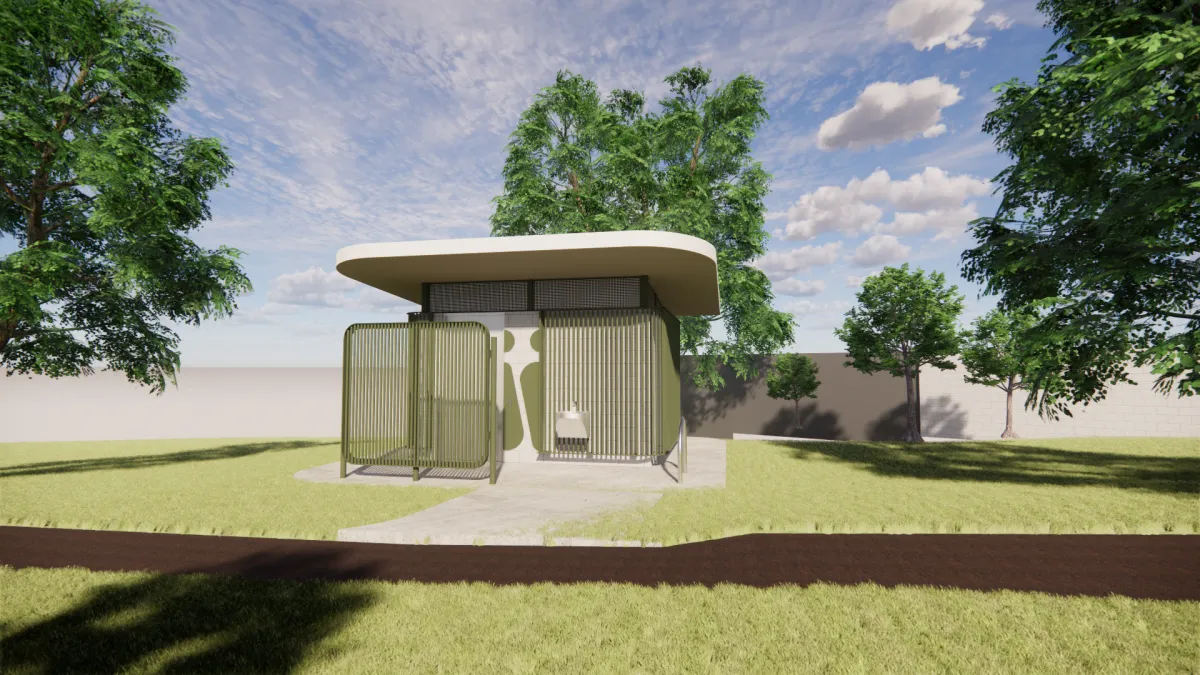 Front of a green and cream toilet block. It joins onto a brown path and has medium to large sized trees around it.