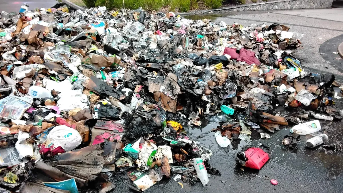 Pile of burnt waste after fire in recycling truck