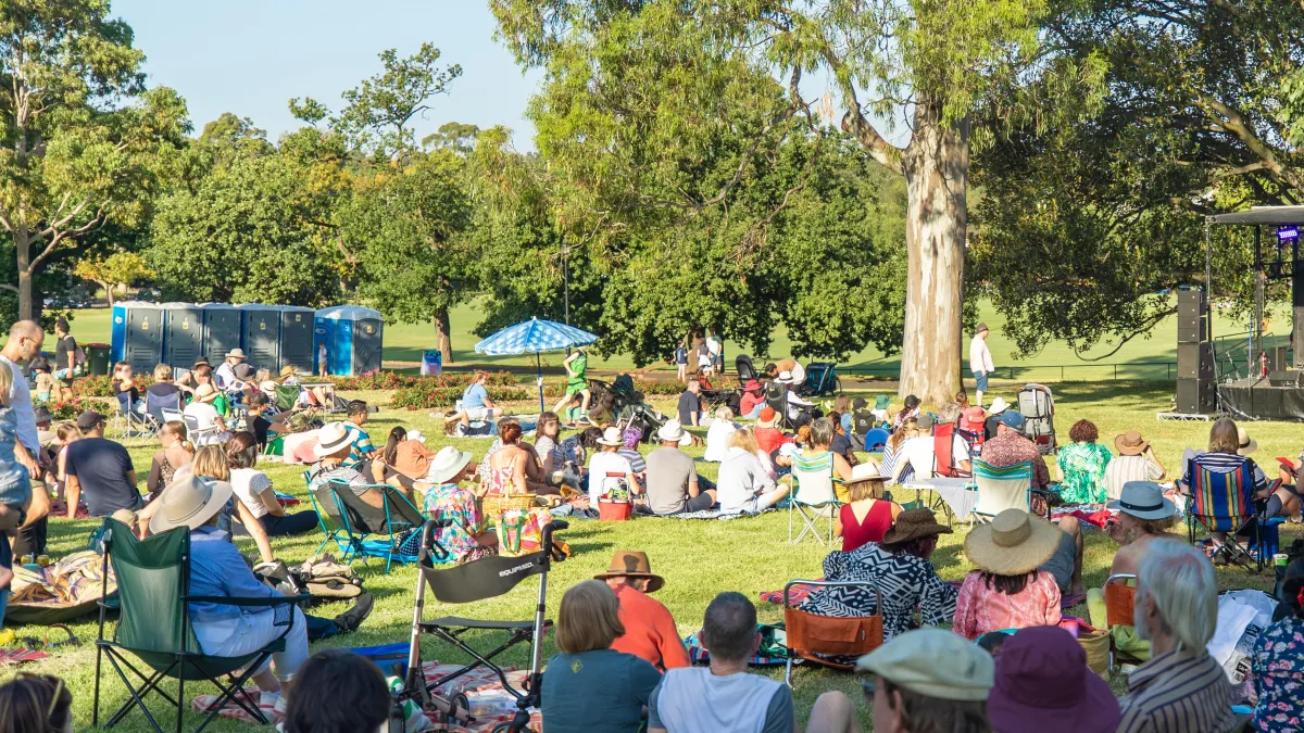 People in camp chairs sitting in a park